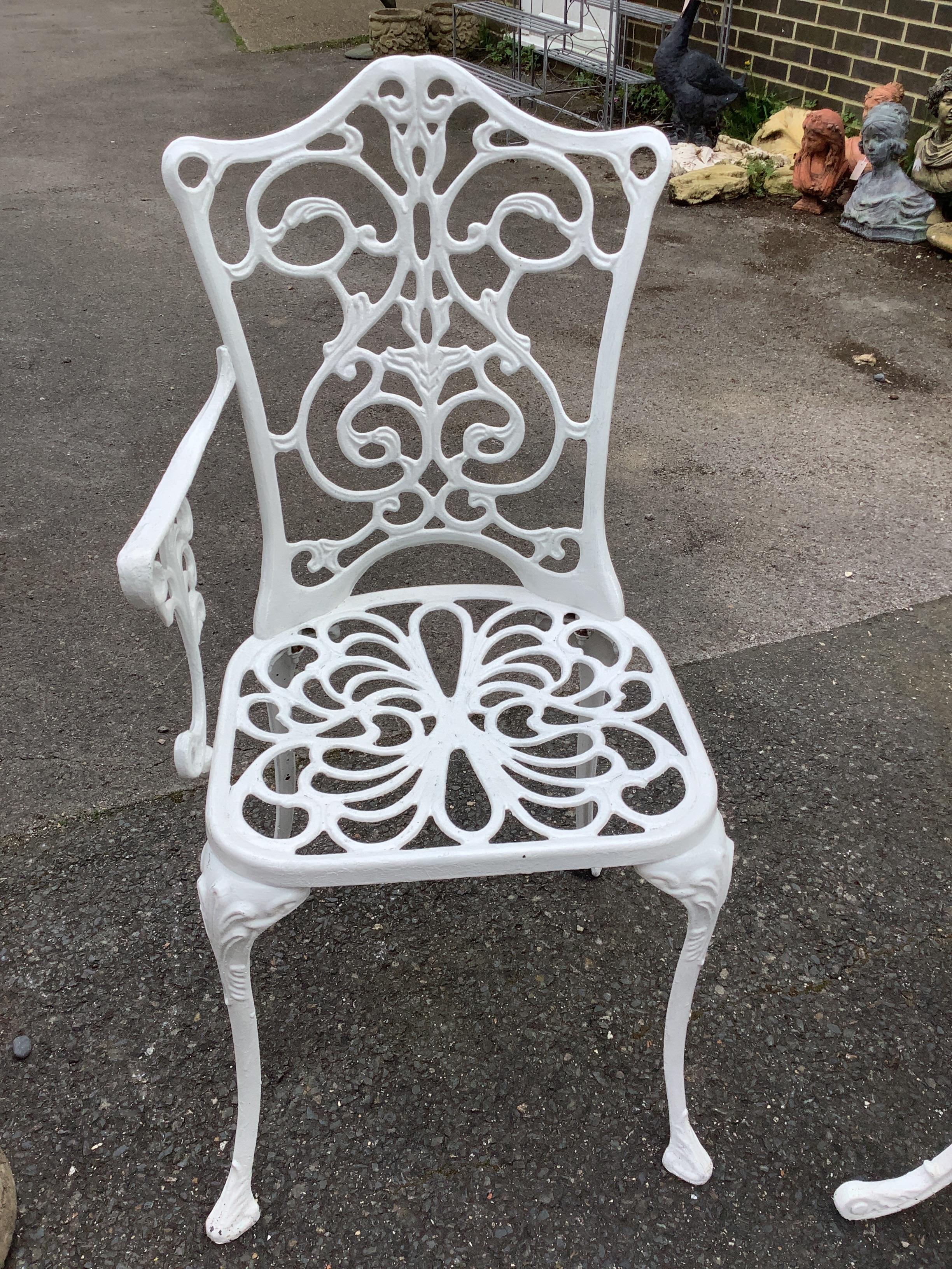 A Victorian style painted aluminium circular garden table, diameter 68cm, height 65cm together with two similar painted chairs (one a.f.)